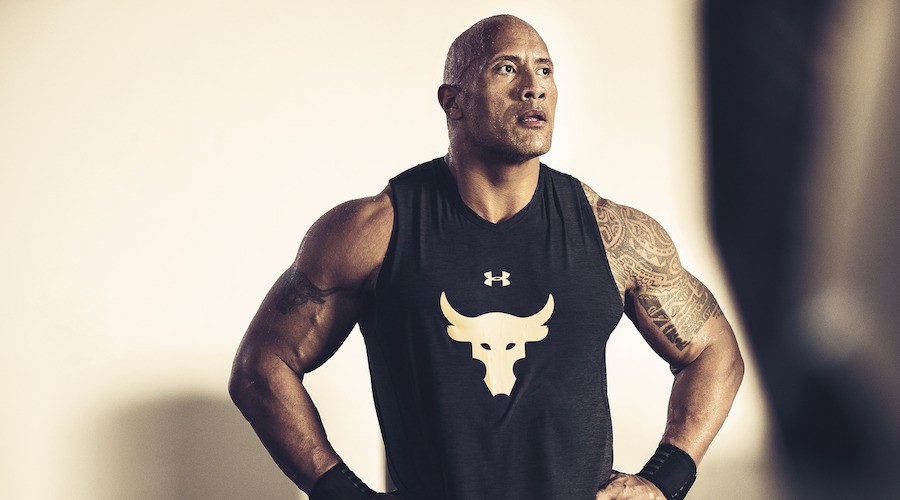 The Rock wearing a black Under Armour shirt posing